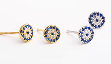 Load image into Gallery viewer, Sterling silver and gold-plated sterling silver evil eye stud earrings with blue and white cubic zirconia stones, protective talisman jewellery symbolizing luck and protection, displayed on a white background.
