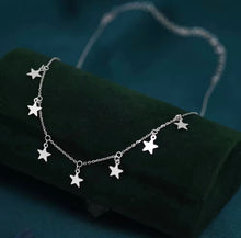 Load image into Gallery viewer, Close up of silver star charm necklace with delicate chain, stainless steel celestial jewelry
