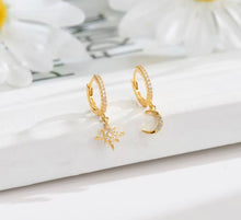 Load image into Gallery viewer, Gold plated sterling silver crystal mismatched moon and star huggie earrings
