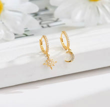 Load image into Gallery viewer, Gold plated sterling silver crystal mismatched moon and star huggie earrings
